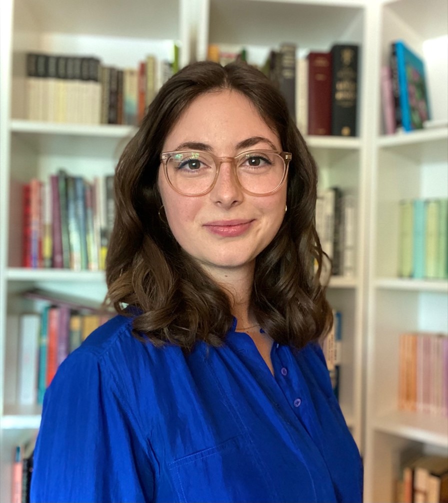 Portrait of Madalyn Hay in front of bookshelves